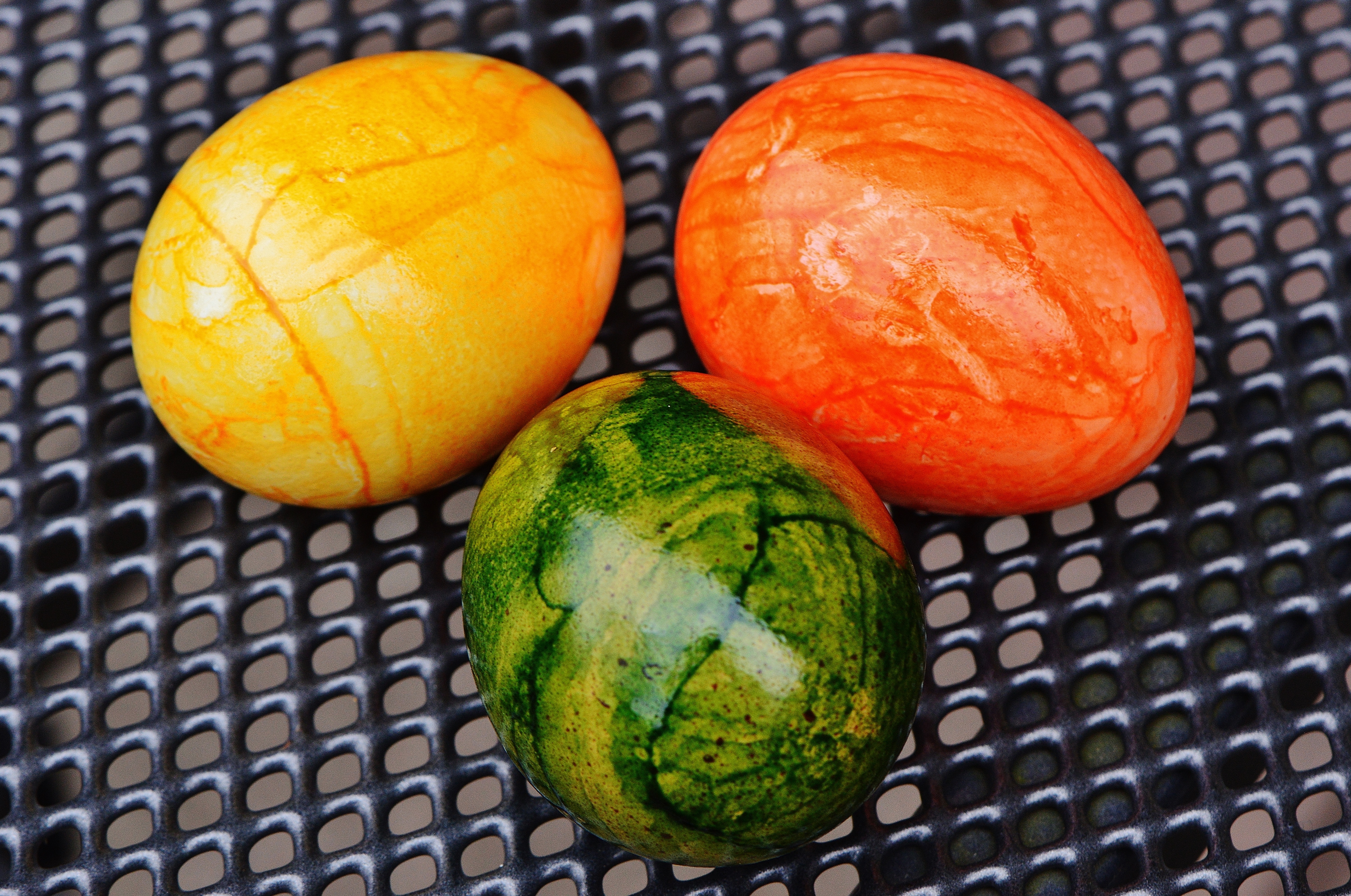 three yellow, orange and green eggs