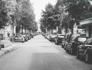 grayscale photography of pathway with many car at the side thumbnail