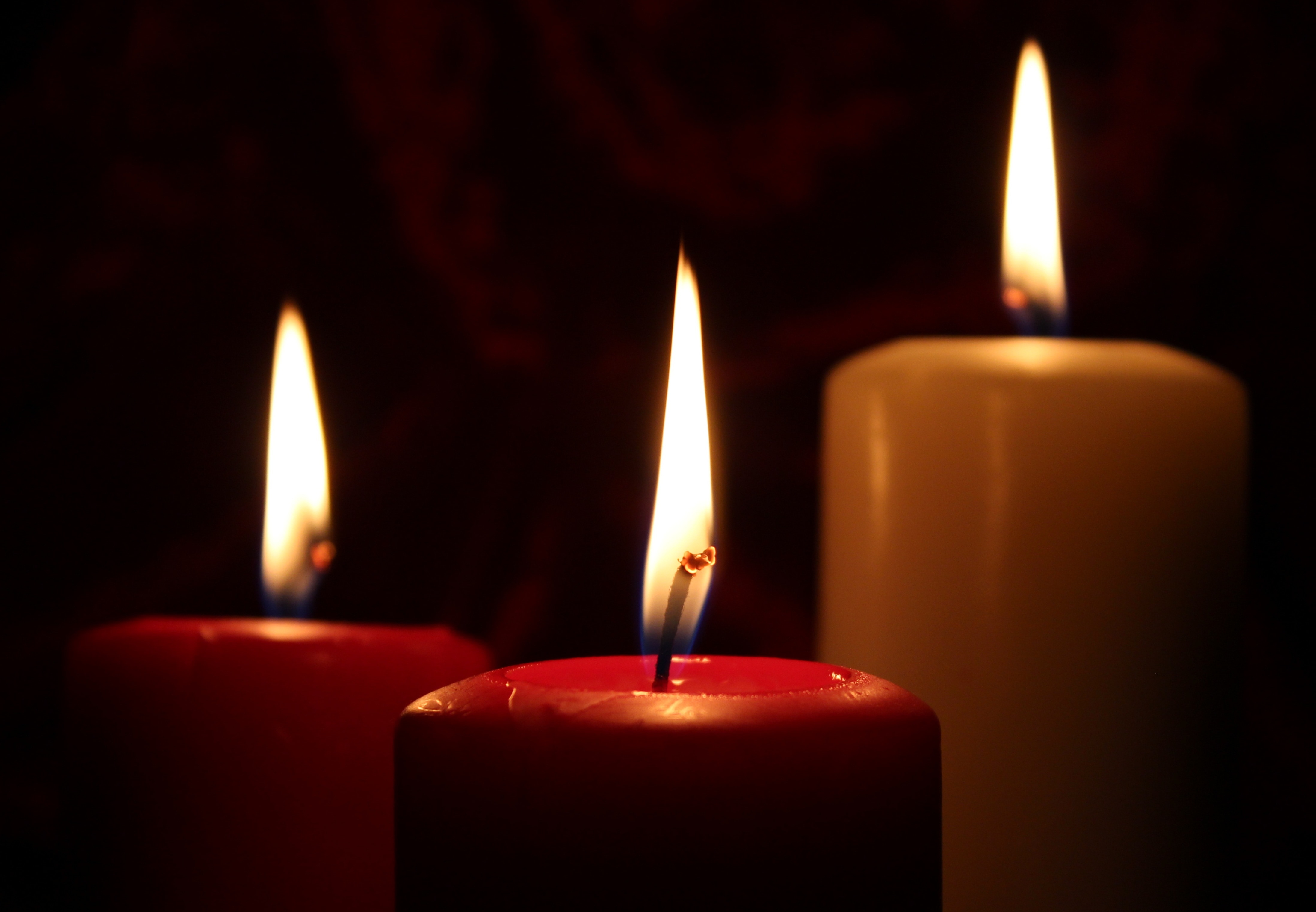 3 lighted pillar candles