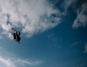 person on air under white and blue sky thumbnail