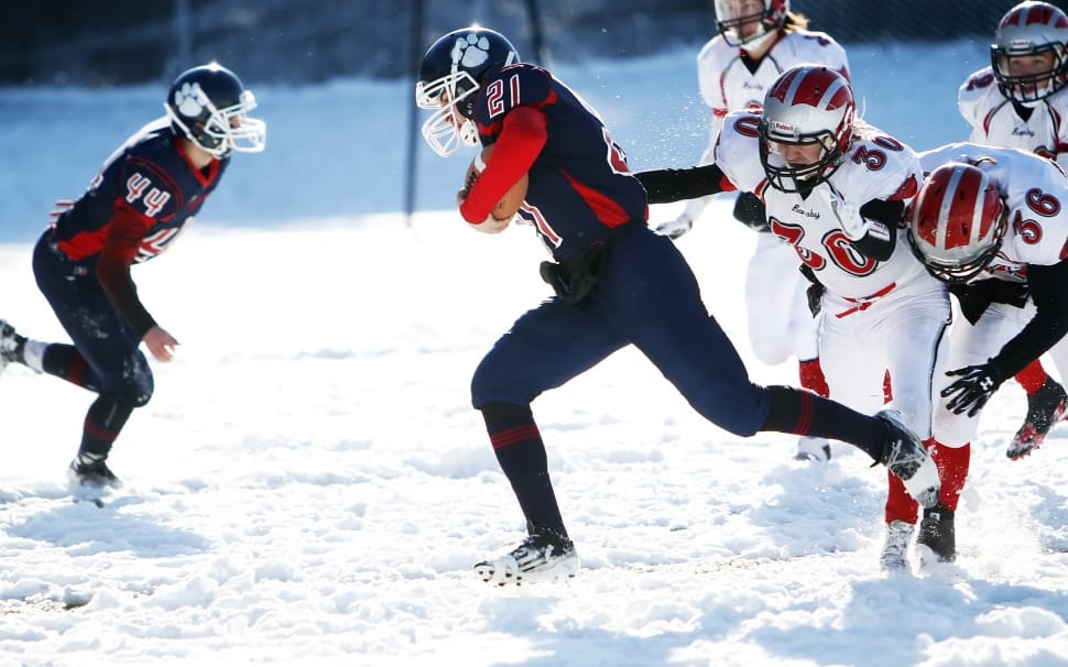 two teams playing football on snow preview