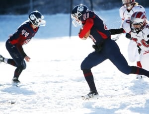 two teams playing football on snow thumbnail