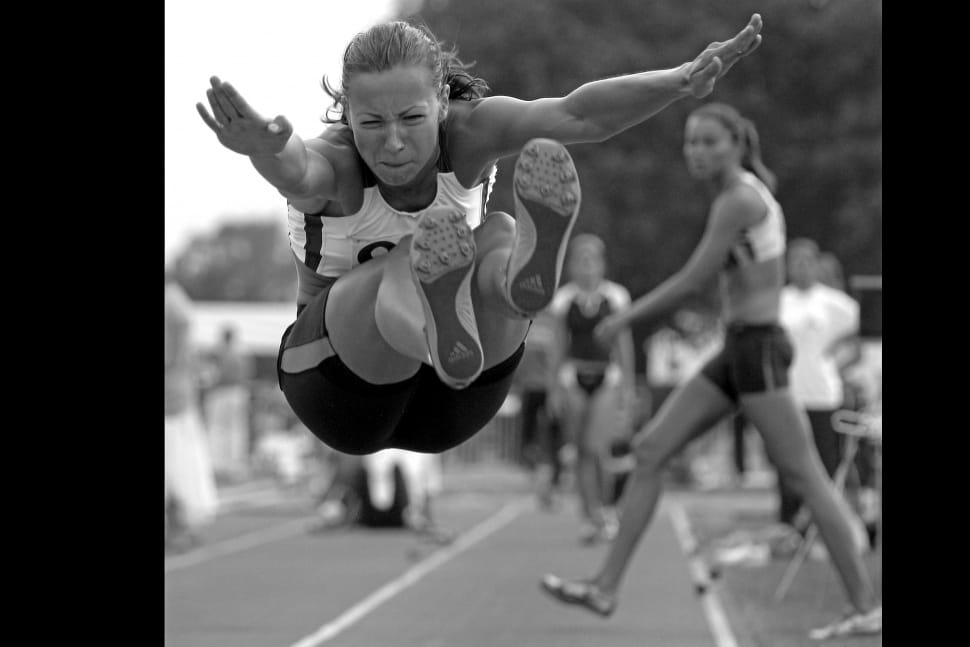 grayscale photo of woman jumping preview
