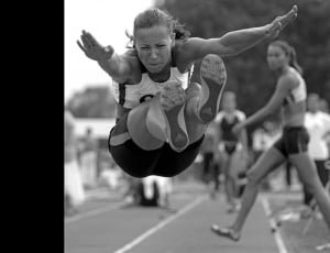 grayscale photo of woman jumping thumbnail