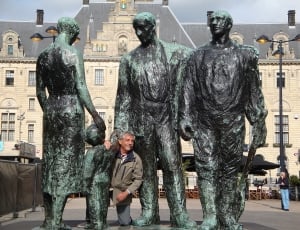black and green statues of men thumbnail