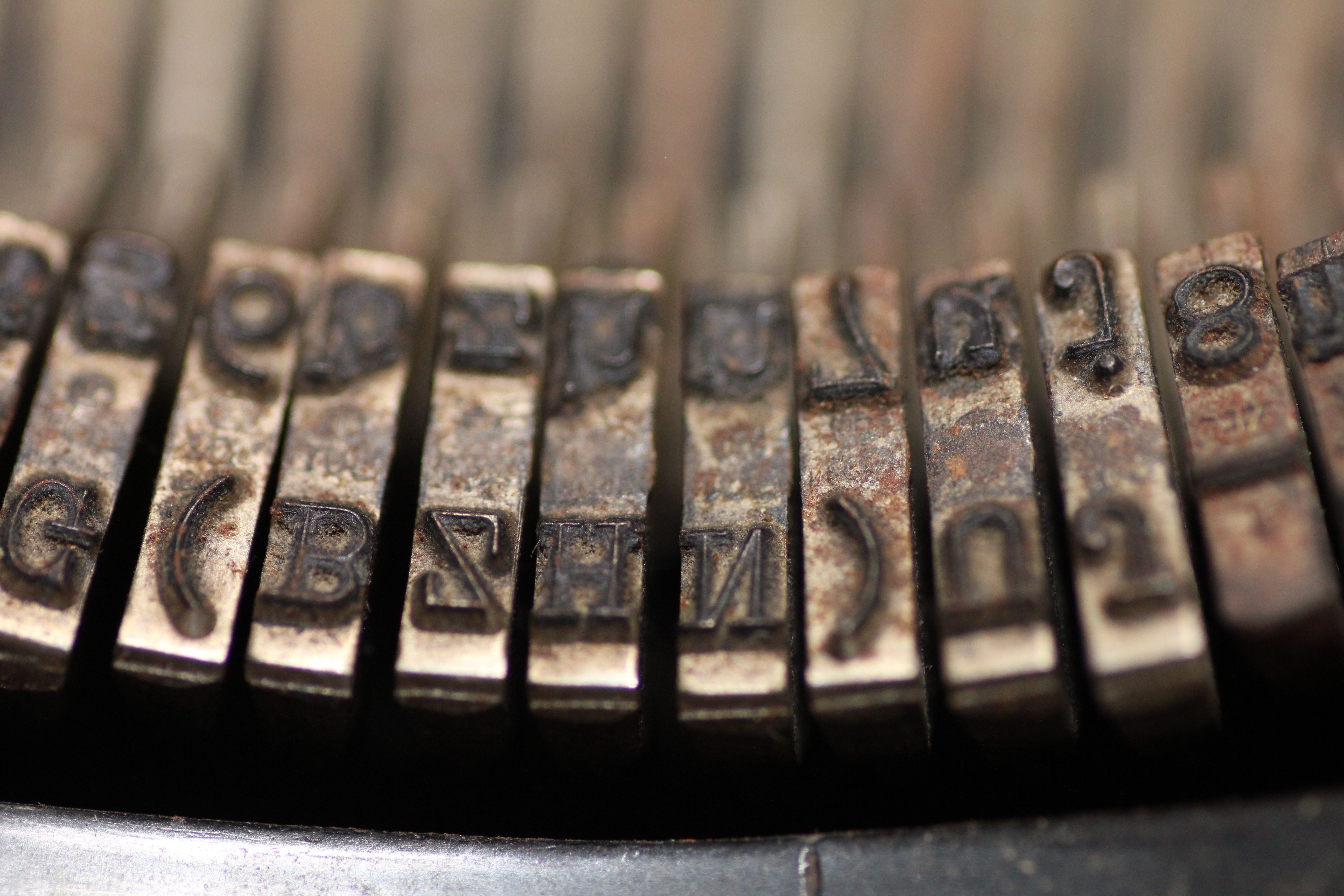 silver and brown steel typewriter part