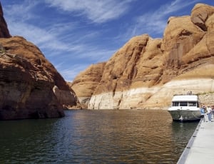 white Yacht near brown rock cliff thumbnail