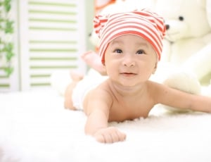 baby's white and red knit hat thumbnail
