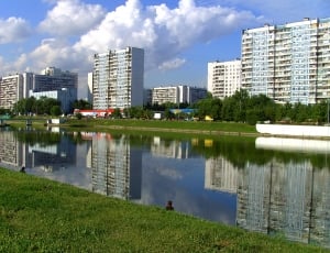 assorted buildings beside green trees during daytime thumbnail
