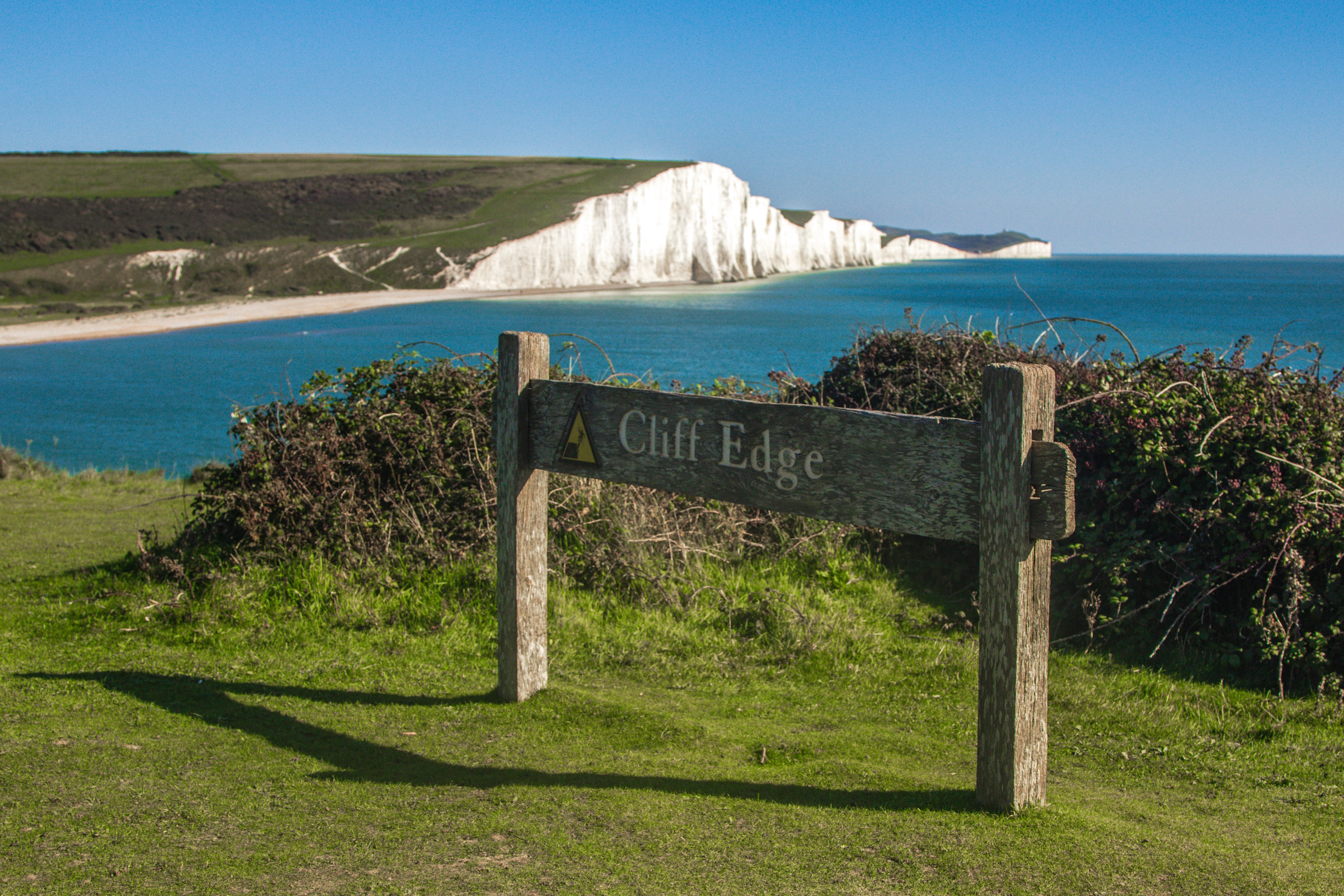 brown wooden clif edge signage