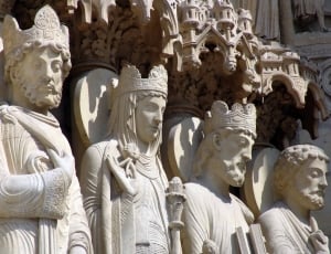 photo of four gray king statues thumbnail