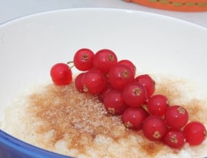 red round fruits on white ceramic bowl thumbnail