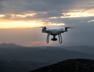 photography of white quadcopter during sunset thumbnail