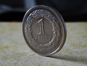 shallow focus photography of round silver 1 coin thumbnail