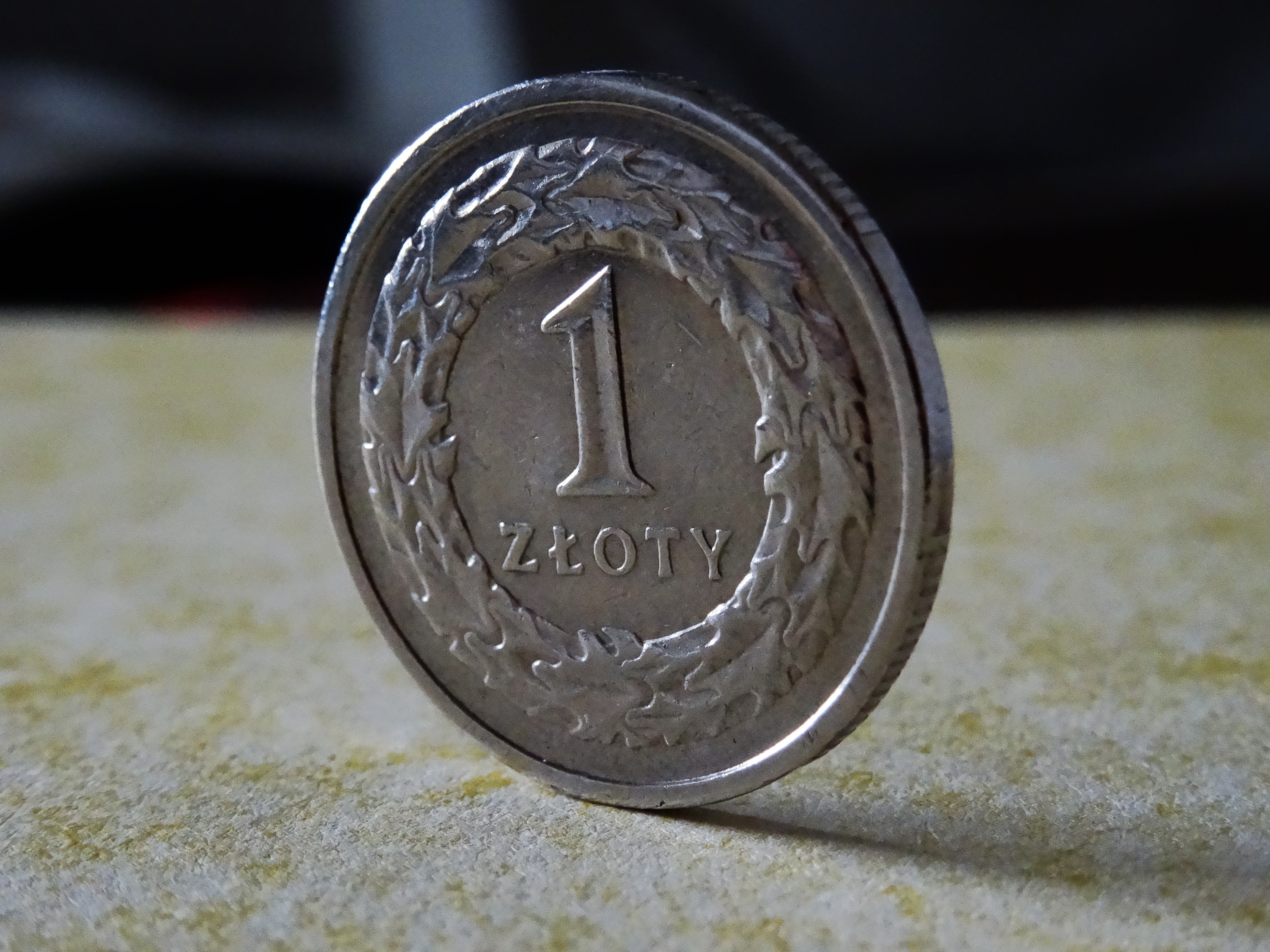 shallow focus photography of round silver 1 coin