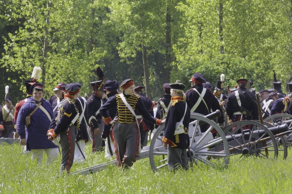 people at the field wearing uniforms with cannons during day preview