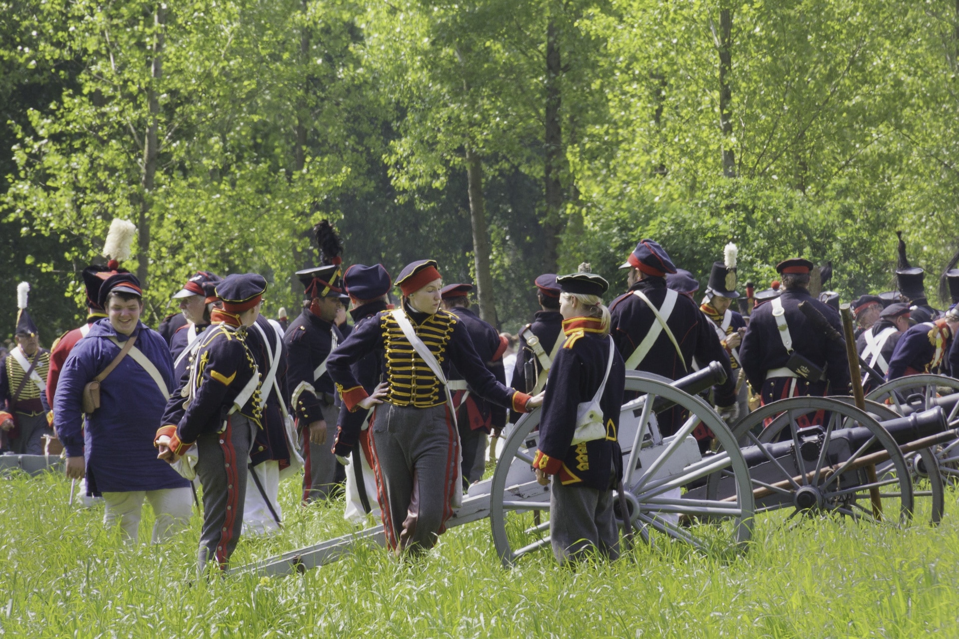 people at the field wearing uniforms with cannons during day
