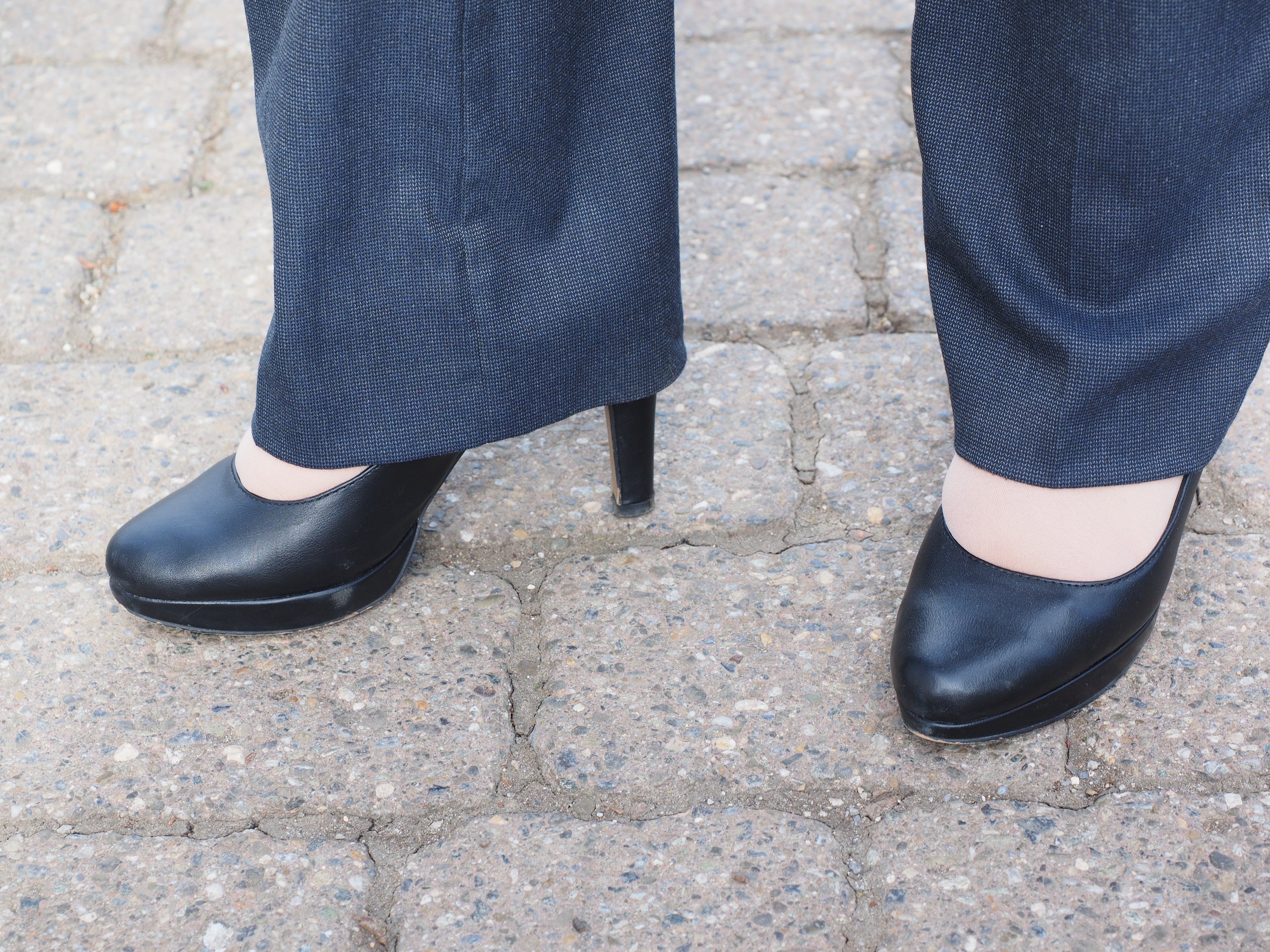 black leather platform heeled shoes and gray dress pants
