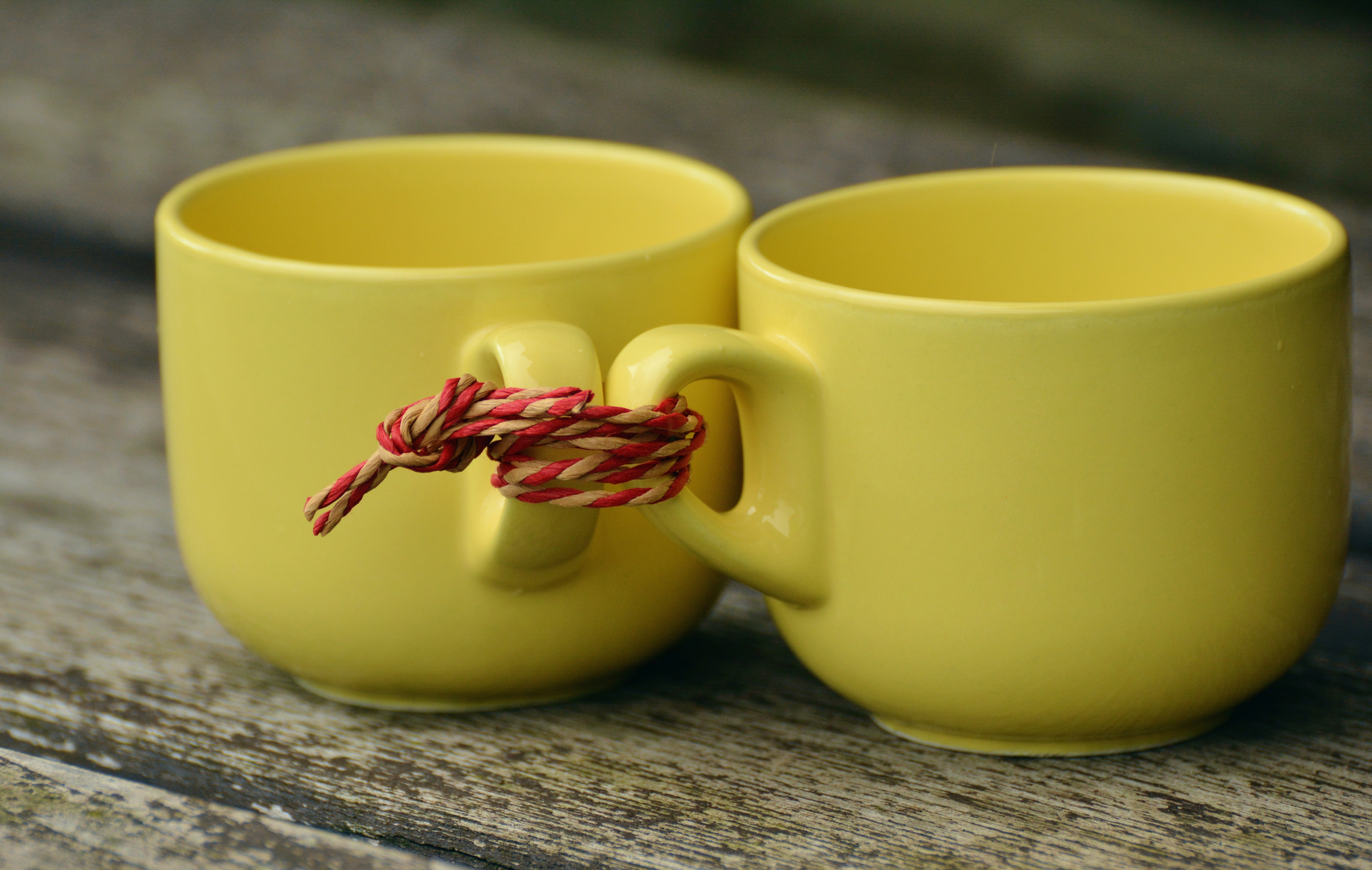 2 yellow ceramic teacup