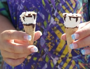 person holding two ice creams thumbnail