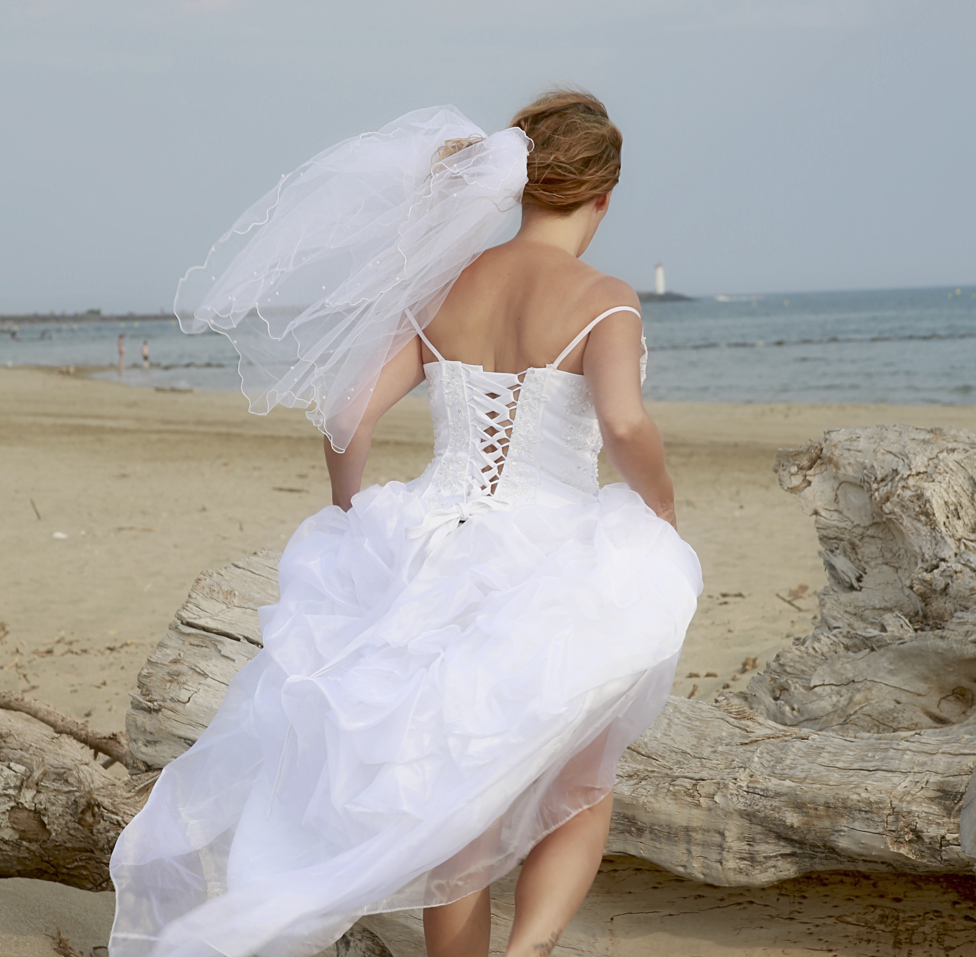 women's white spaghetti strap wedding dress and headress