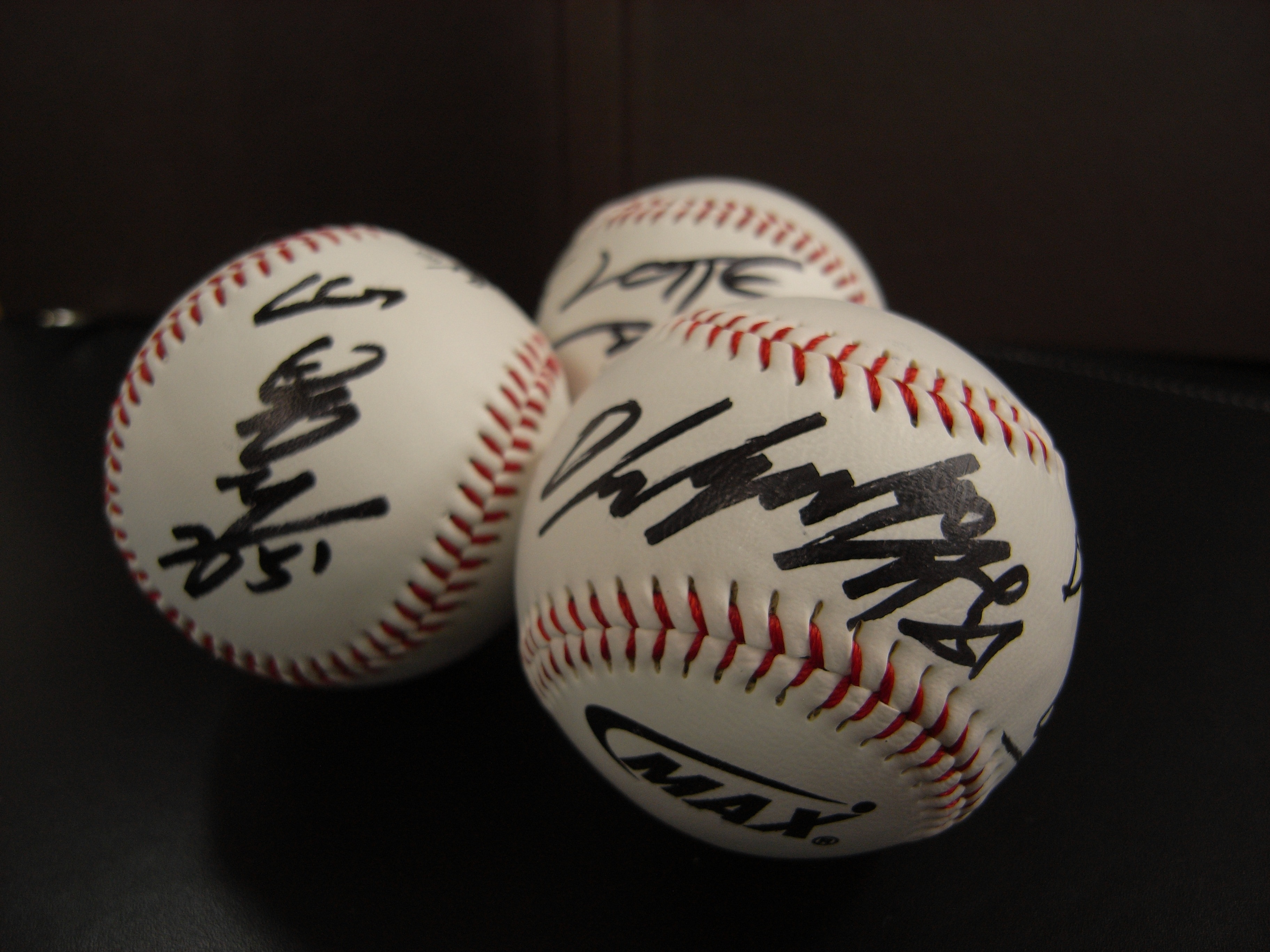 three autographed baseball balls