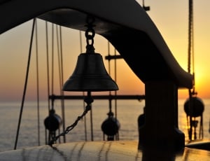 silhouette of chain blocks and bell during sun set thumbnail