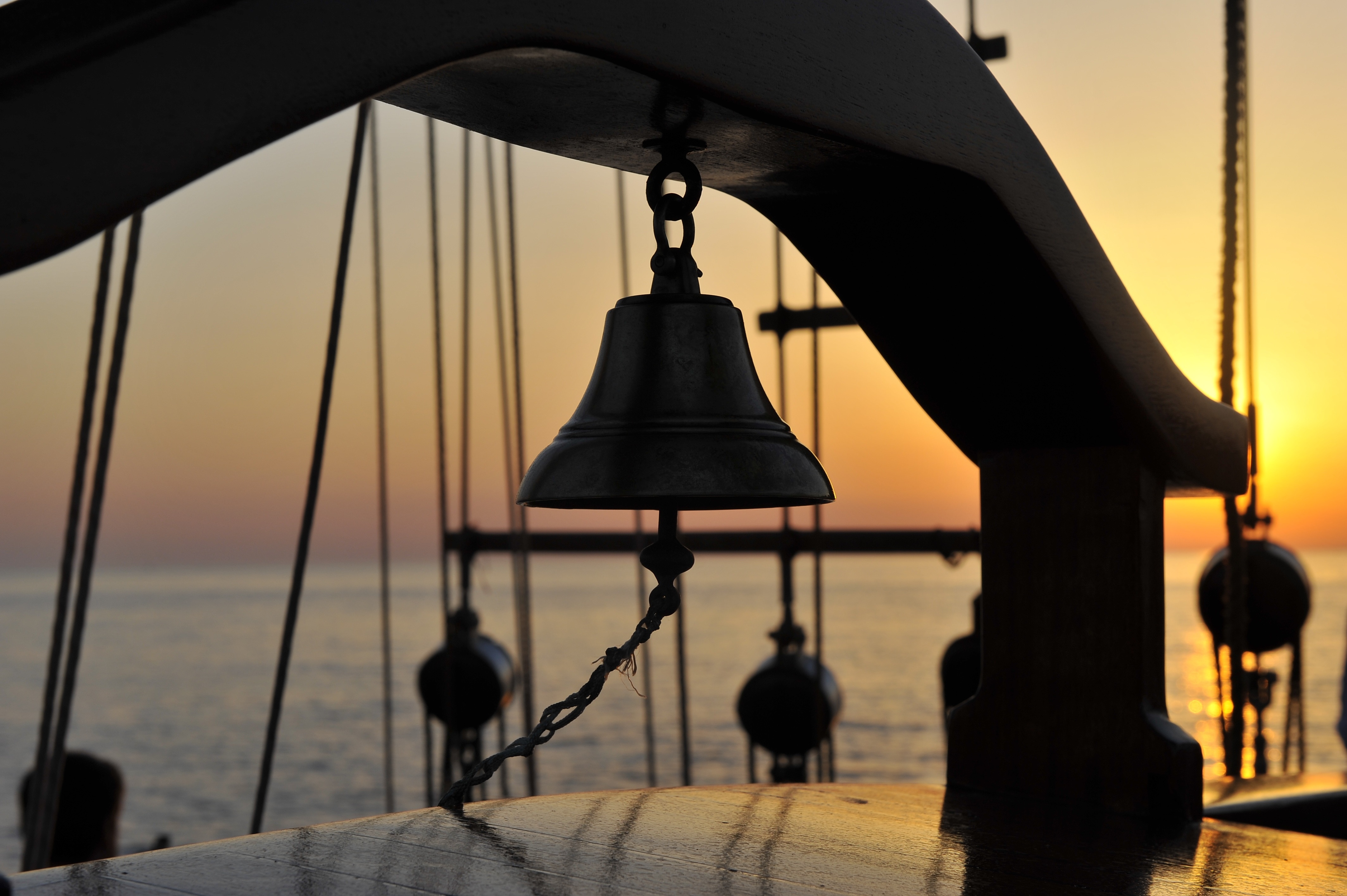 silhouette of chain blocks and bell during sun set