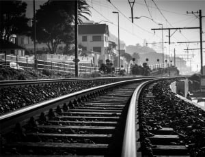 gray scale photo of train tracks thumbnail