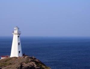 white lighthouse on top of cliff thumbnail
