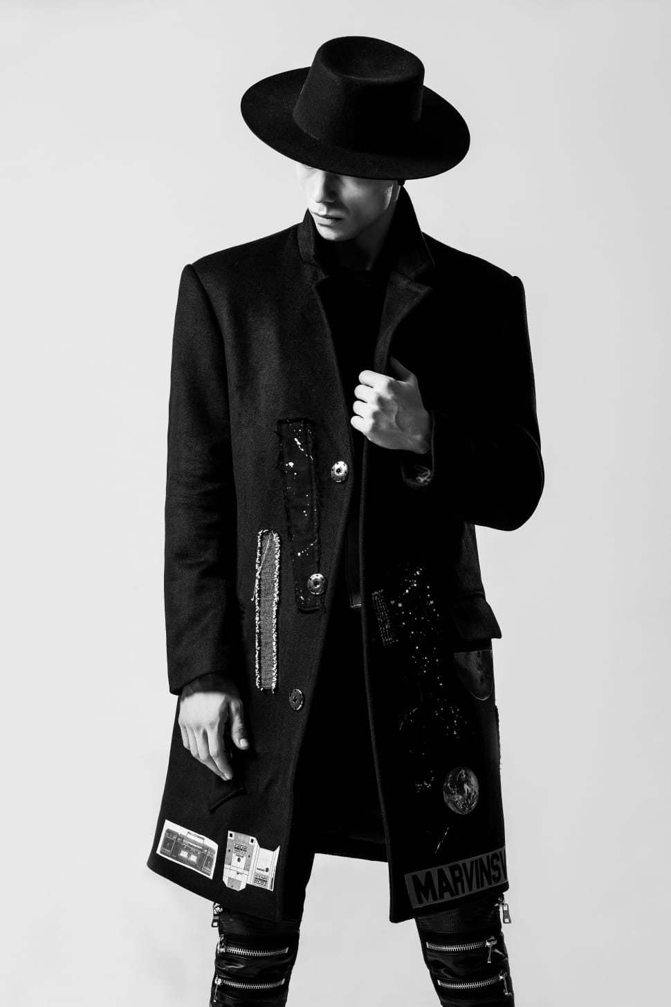 men's black coat jeans and hat preview