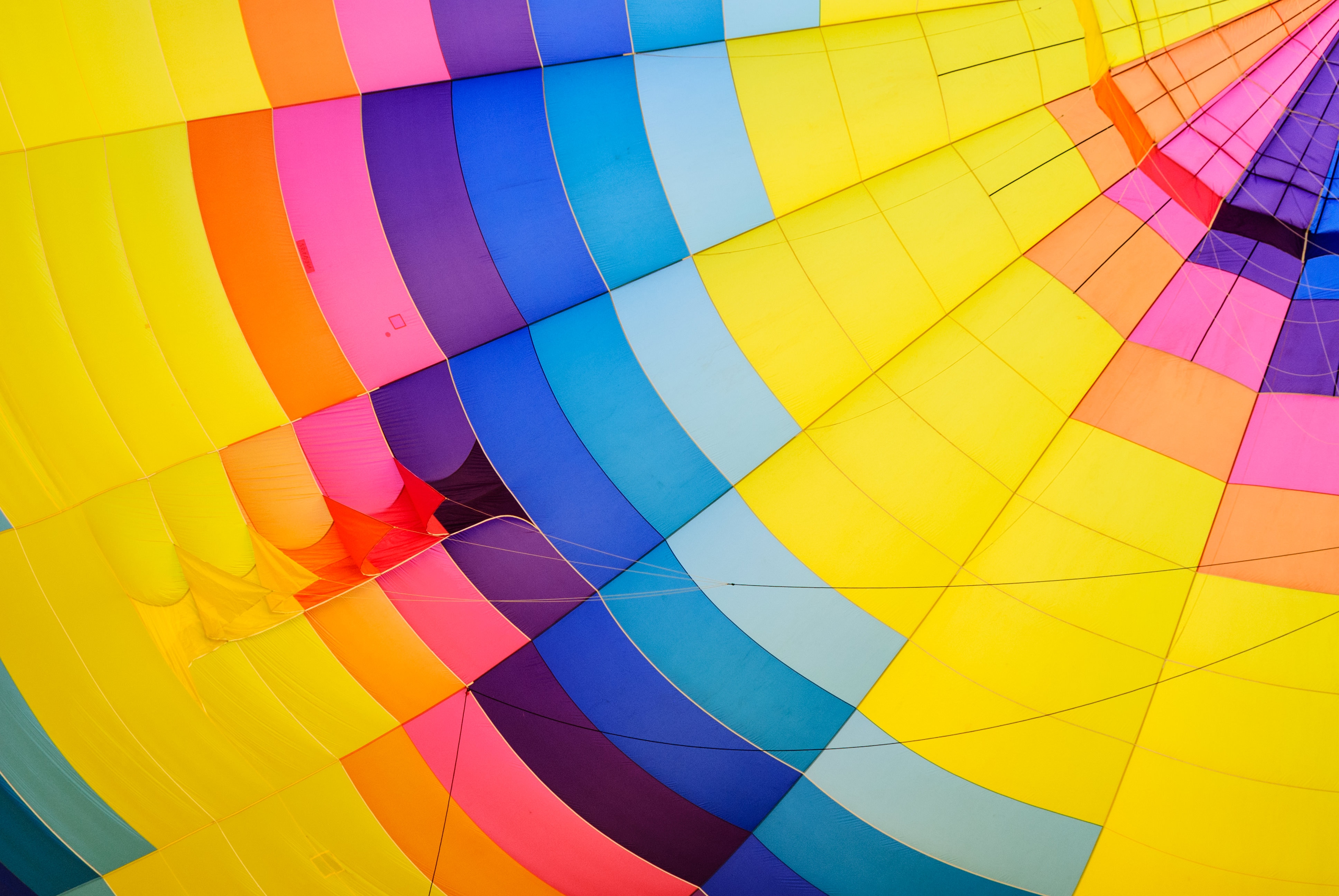 close up photo of yellow, blue and green hot air balloon