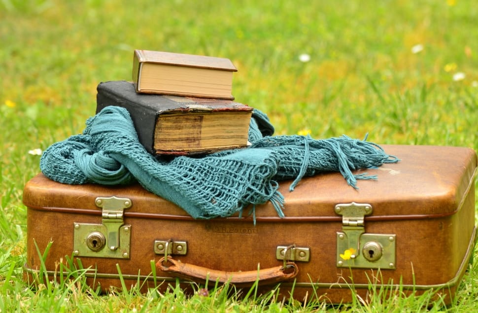 brown luggage teal scarf and books preview