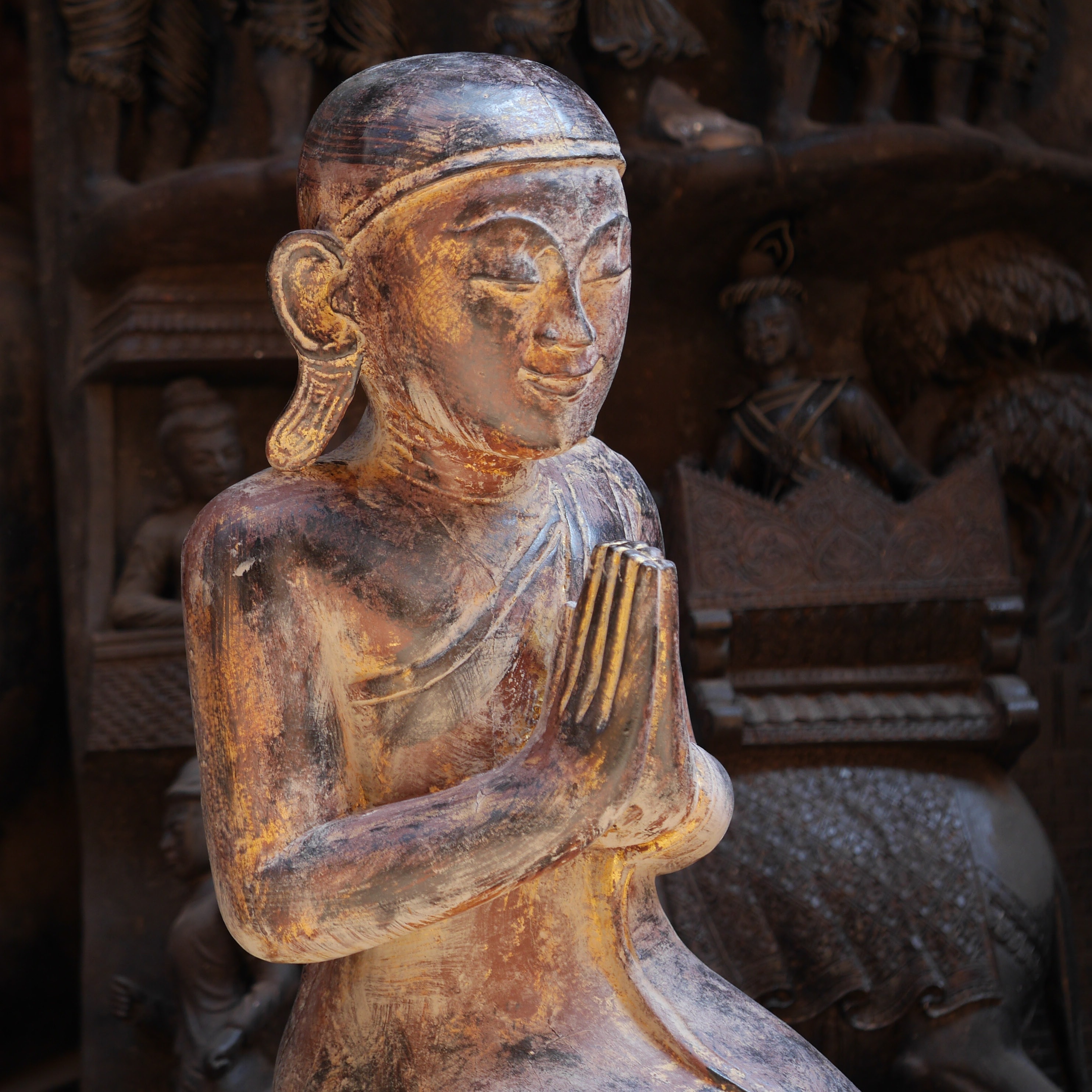 brown wooden Buddhist religious sculpture