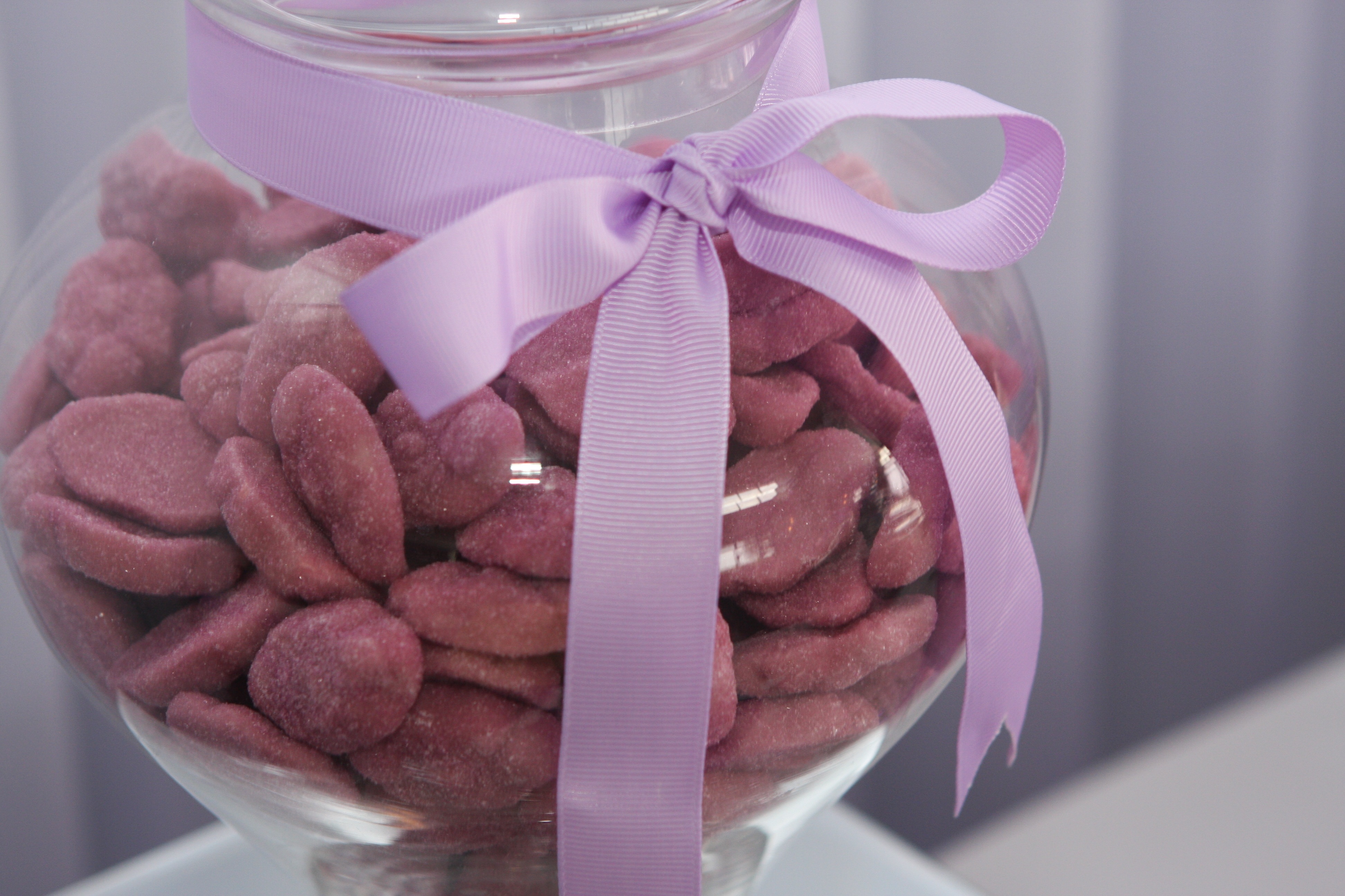 clear glass jar with ribbon and cookies