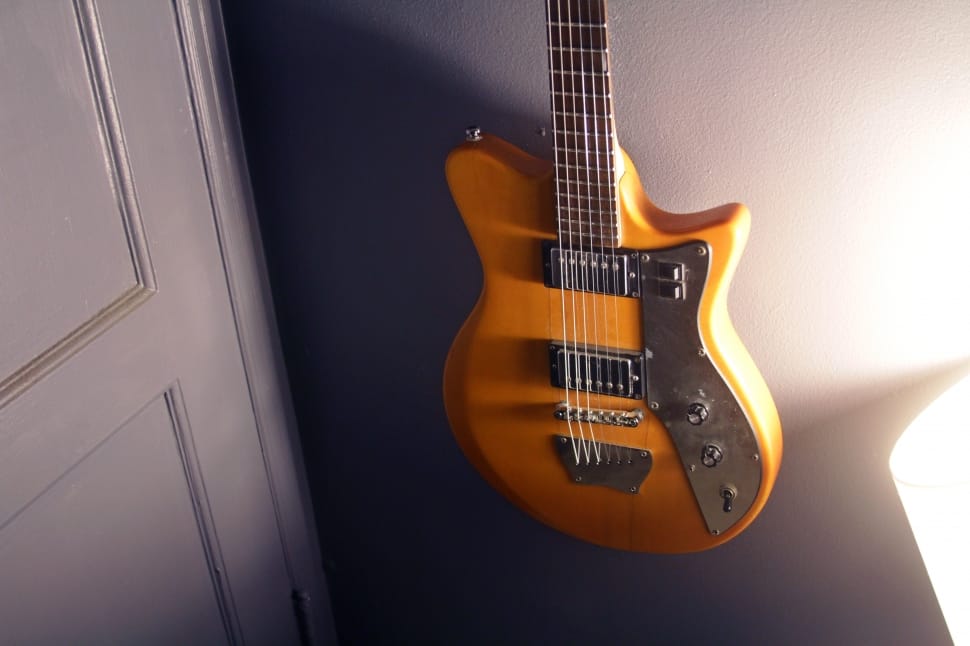 brown and silver electric guitar preview