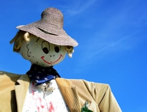 brown suit and white shirt scarecrow like thumbnail