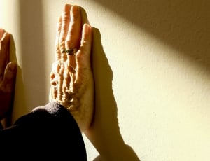 person's two hands leaned on wall thumbnail