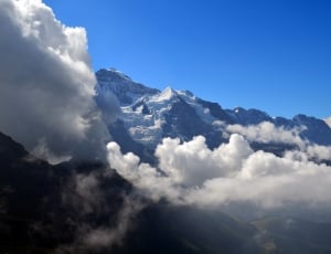 glacier mountain near cloud during daytime thumbnail