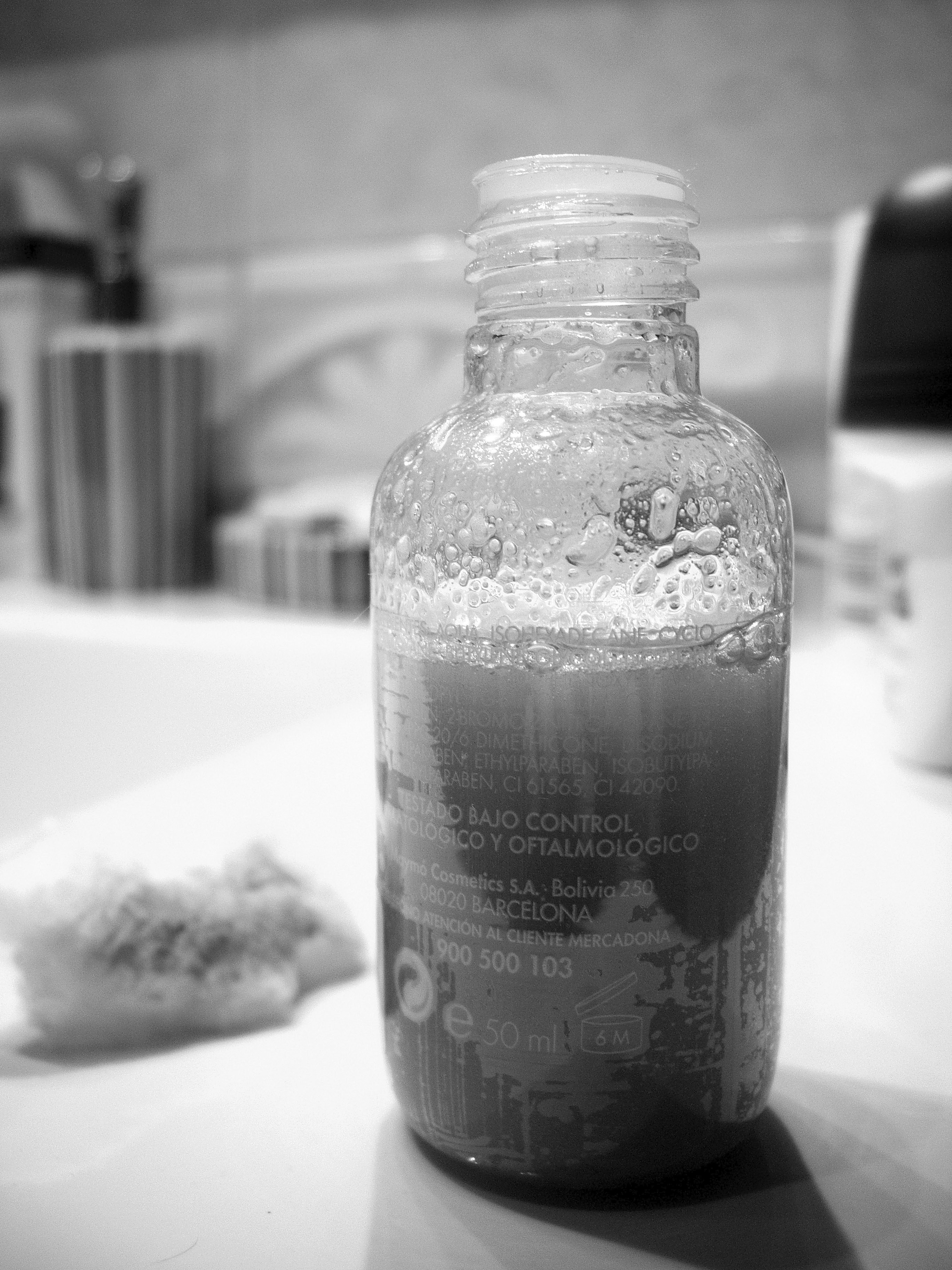 gray liquid filled clear plastic bottle