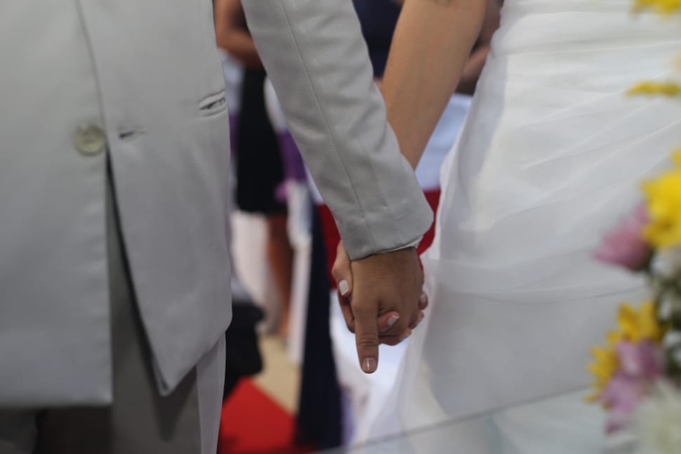 two person holding each other hand during wedding day preview