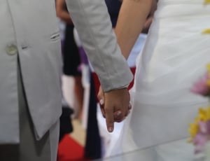 two person holding each other hand during wedding day thumbnail