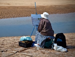 woman painting an ocean thumbnail