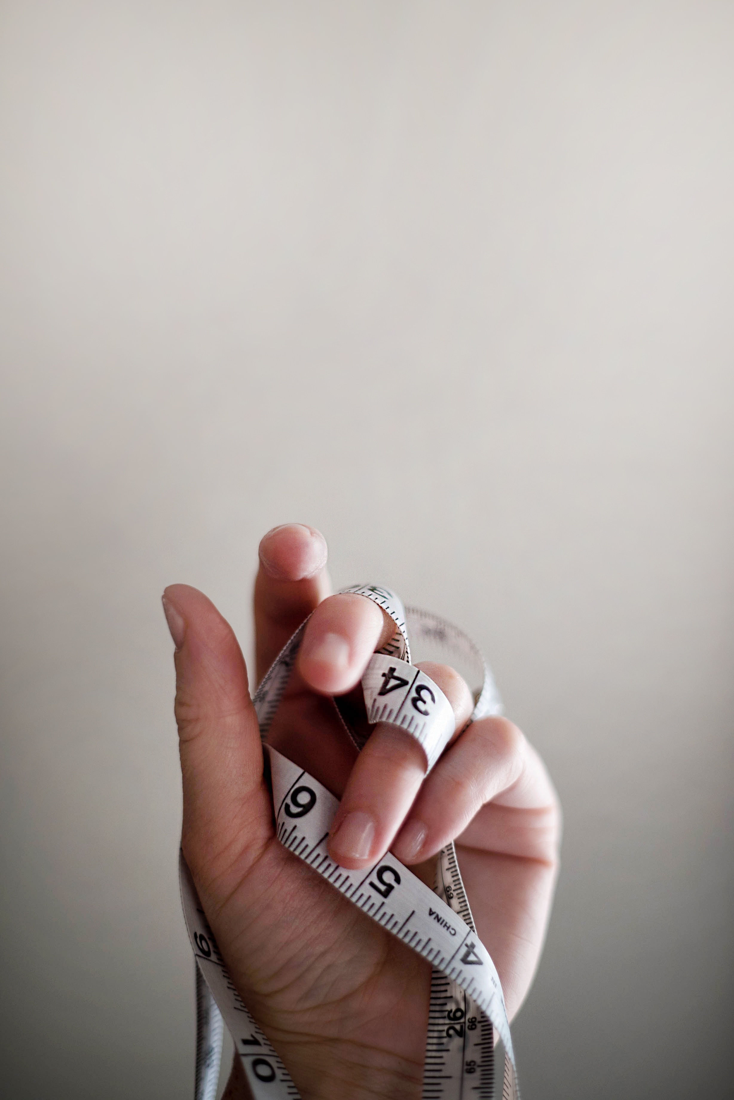 person holding white tape measure
