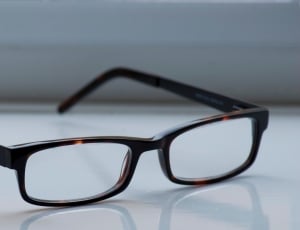 macro photography of brown framed eyeglasses thumbnail