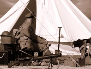 sepia photography of man in army suit thumbnail