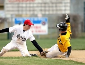 baseball catcher tagging baseball batter sliding on plate base thumbnail
