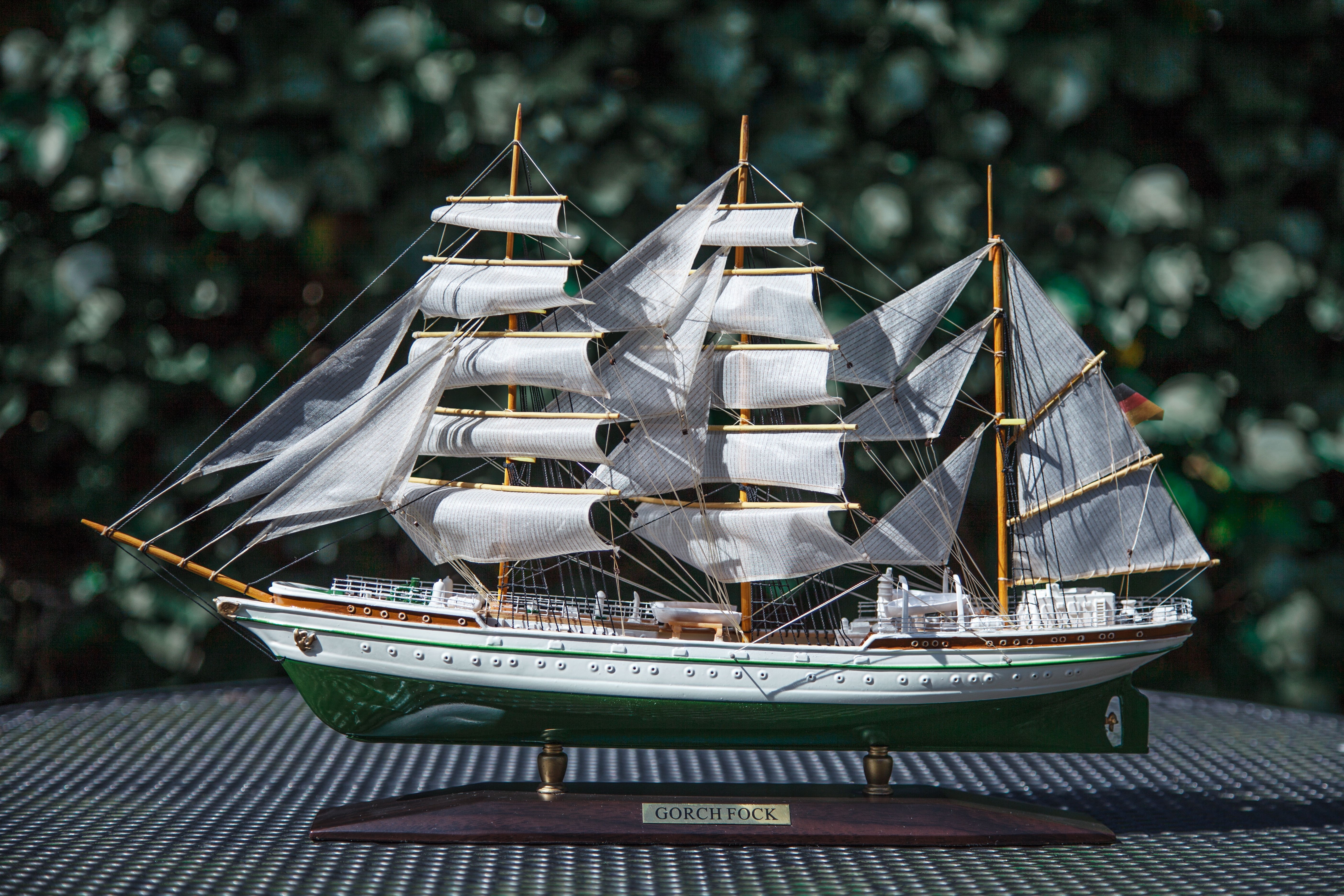 green and white sailboat scale model
