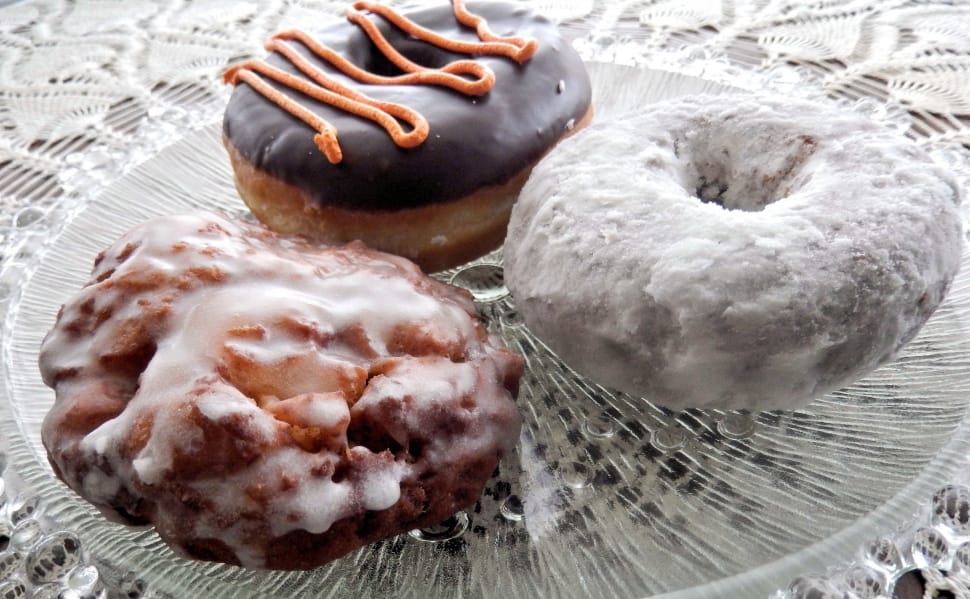 three donuts on clear round glass plate preview