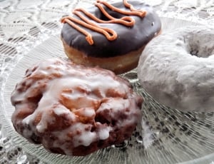 three donuts on clear round glass plate thumbnail